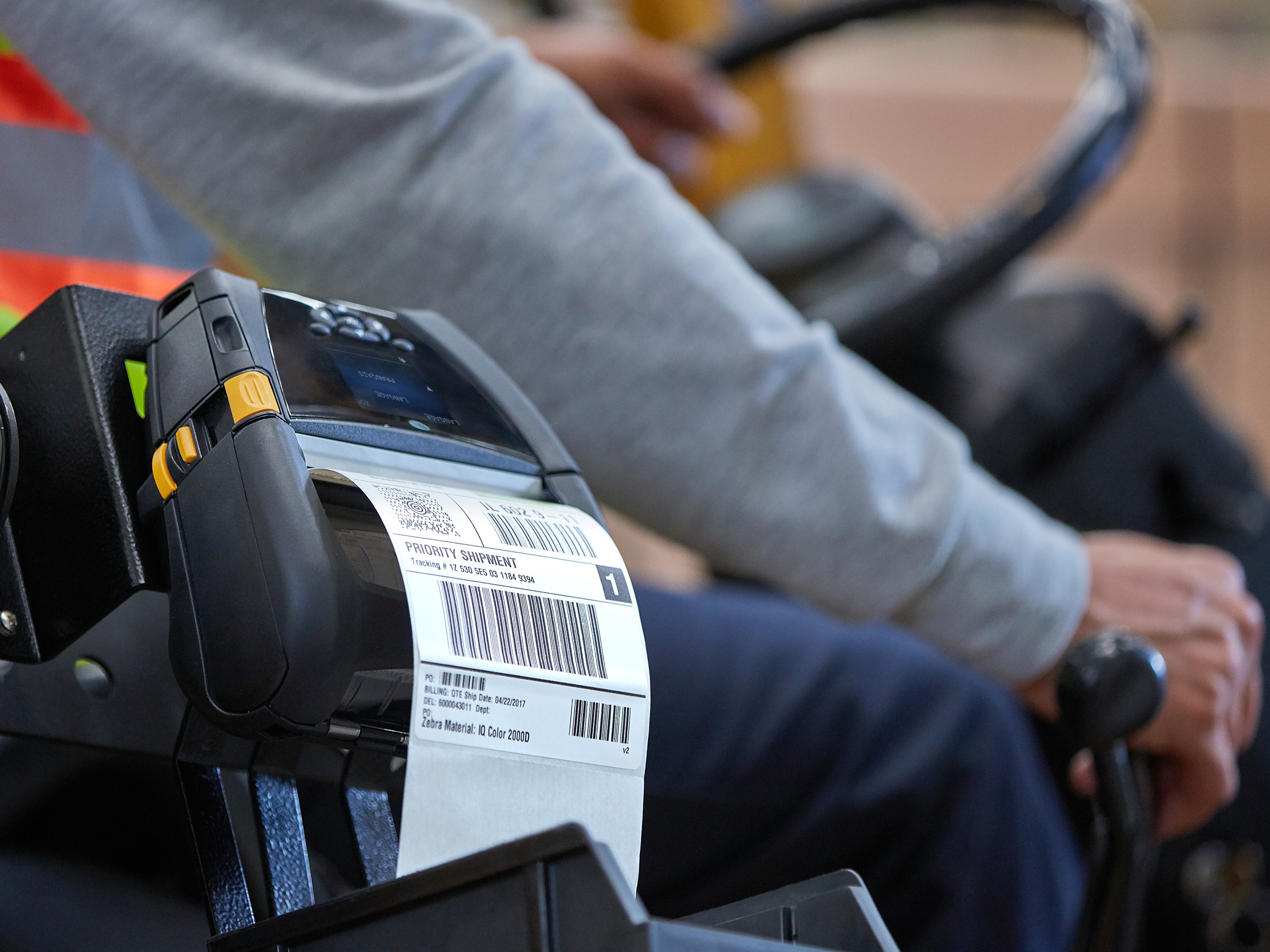 A Zebra mobile printer mounted to a forklift printing a label