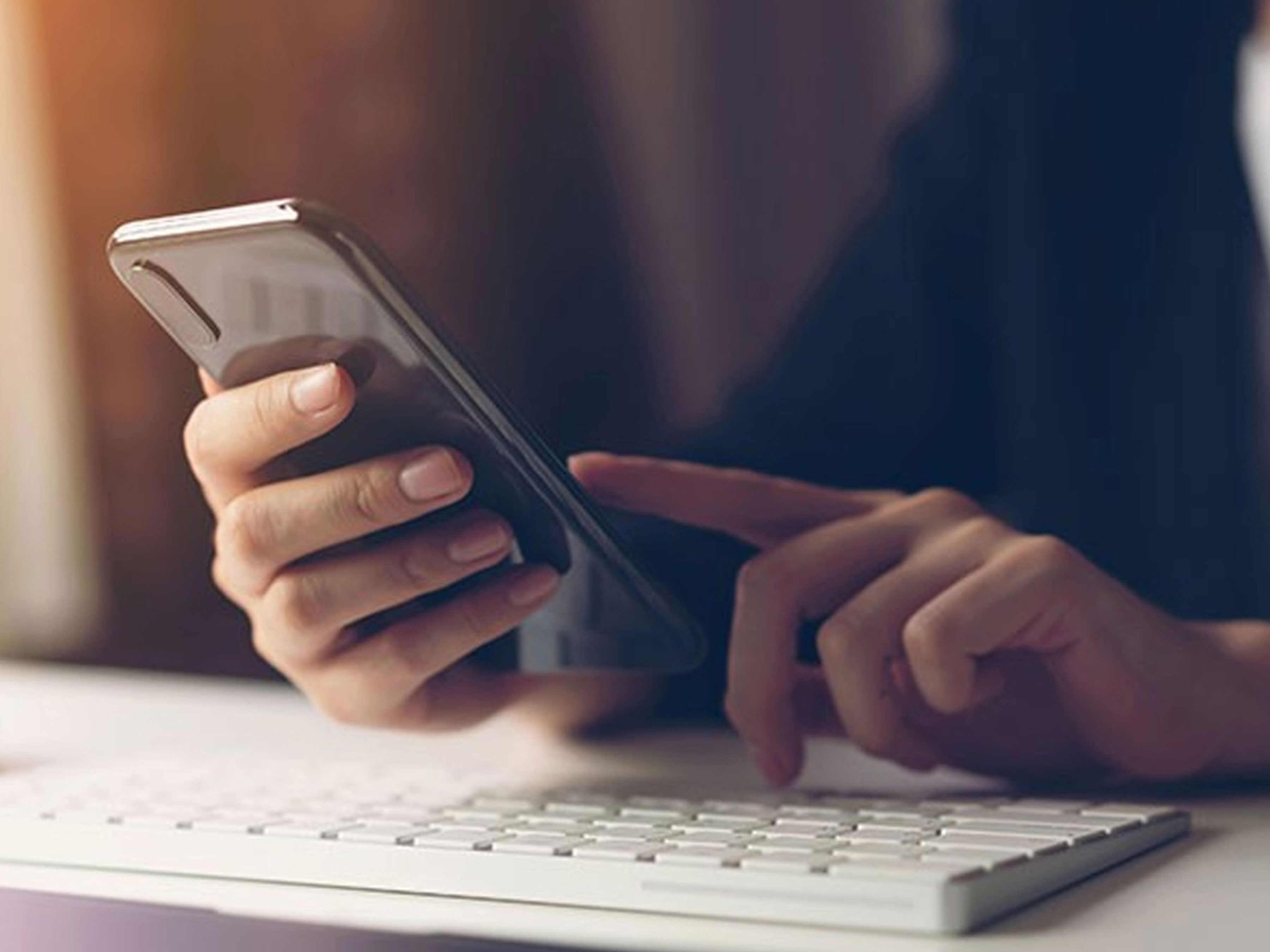 Stock image, person holding a phone