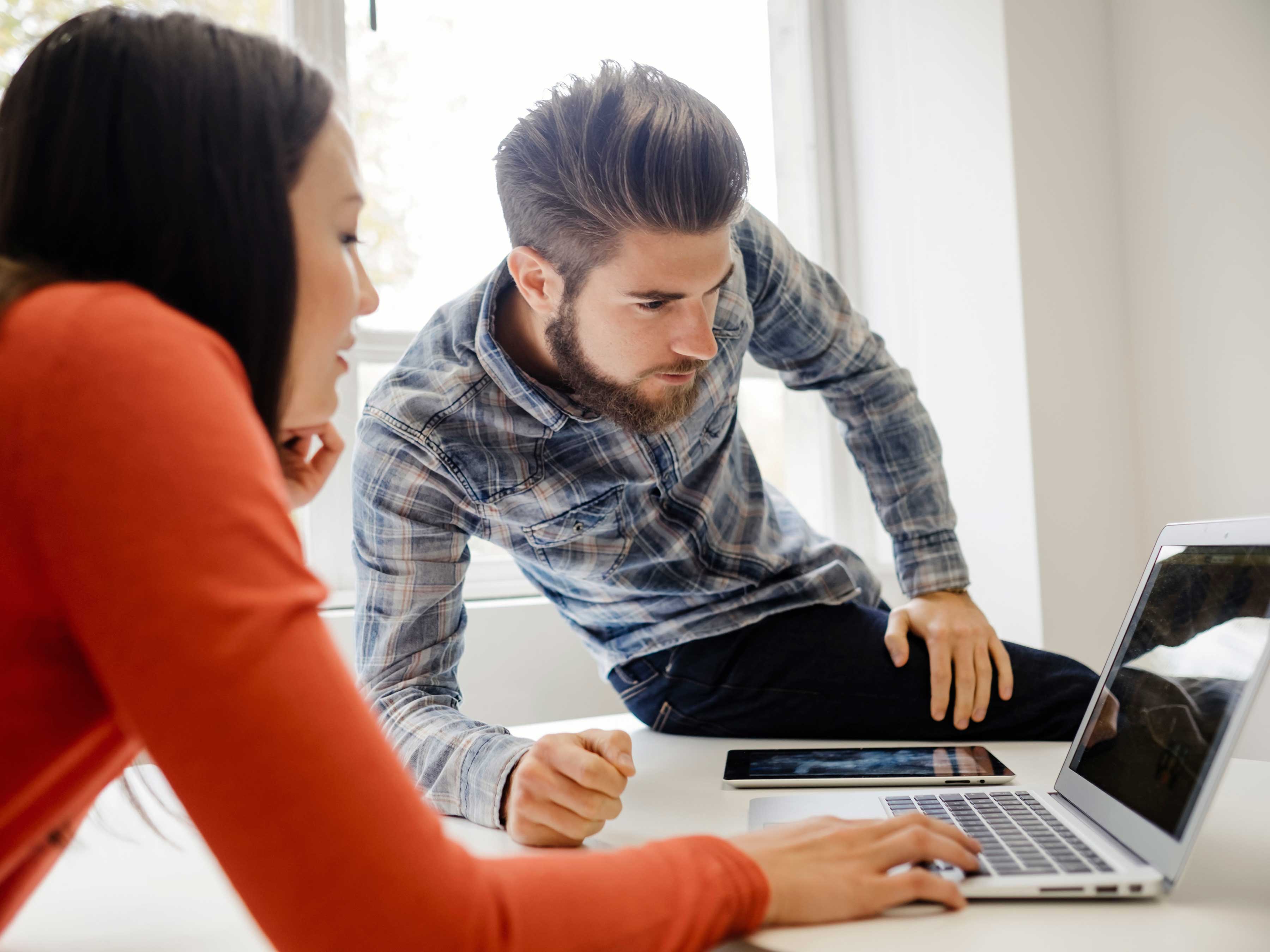 Two people looking at a laptop computer