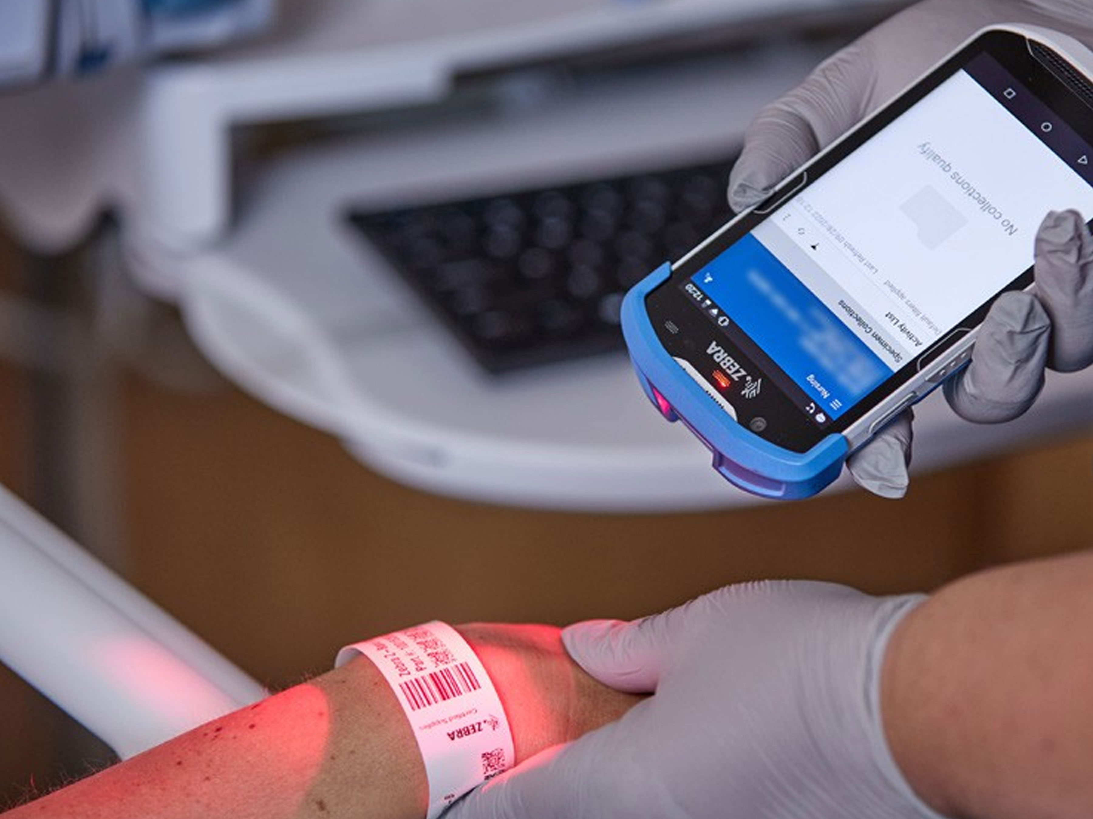 Healthcare worker scanning a patient's wristband