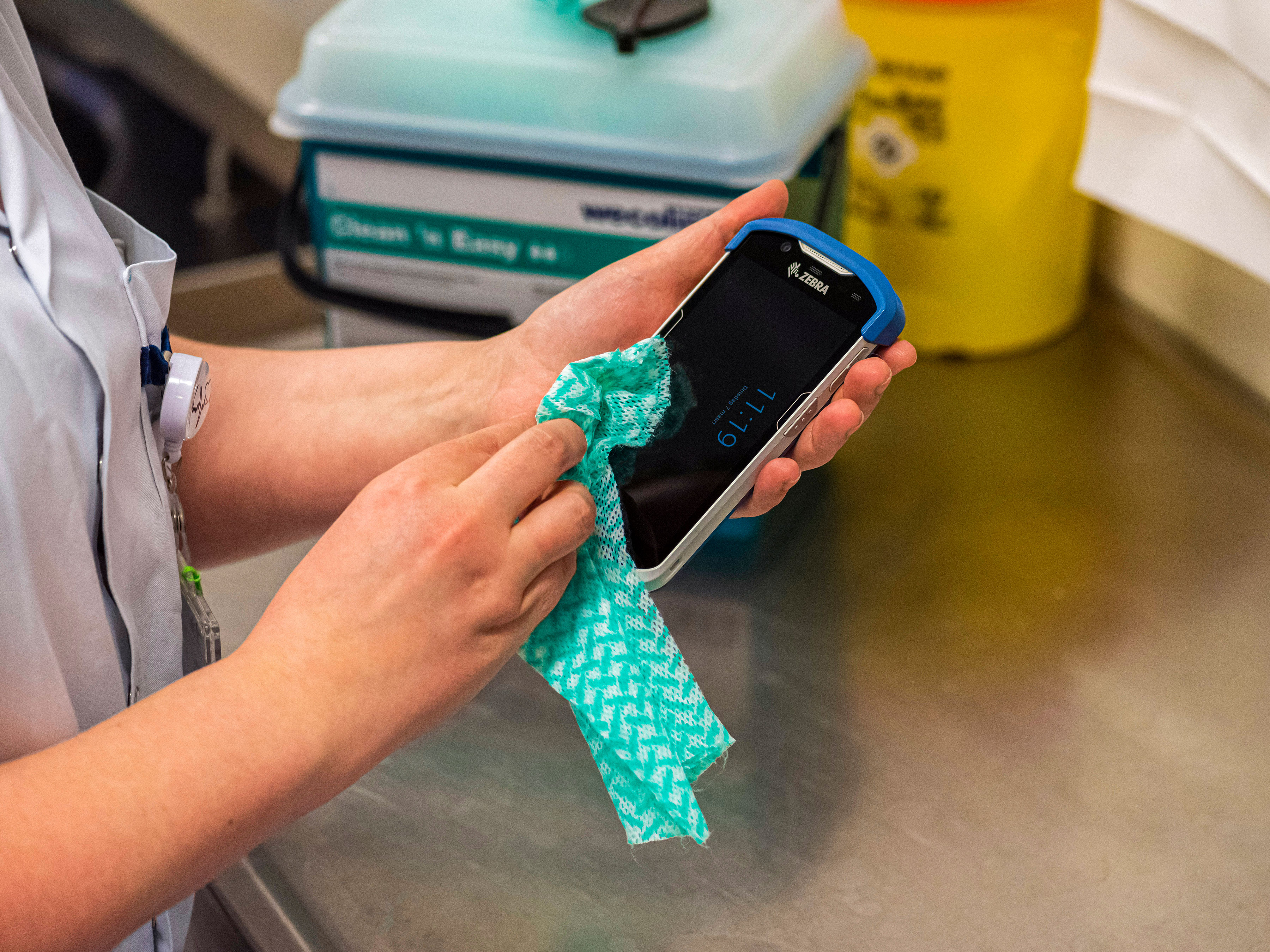 Hospital worker cleaning a Zebra mobile computer