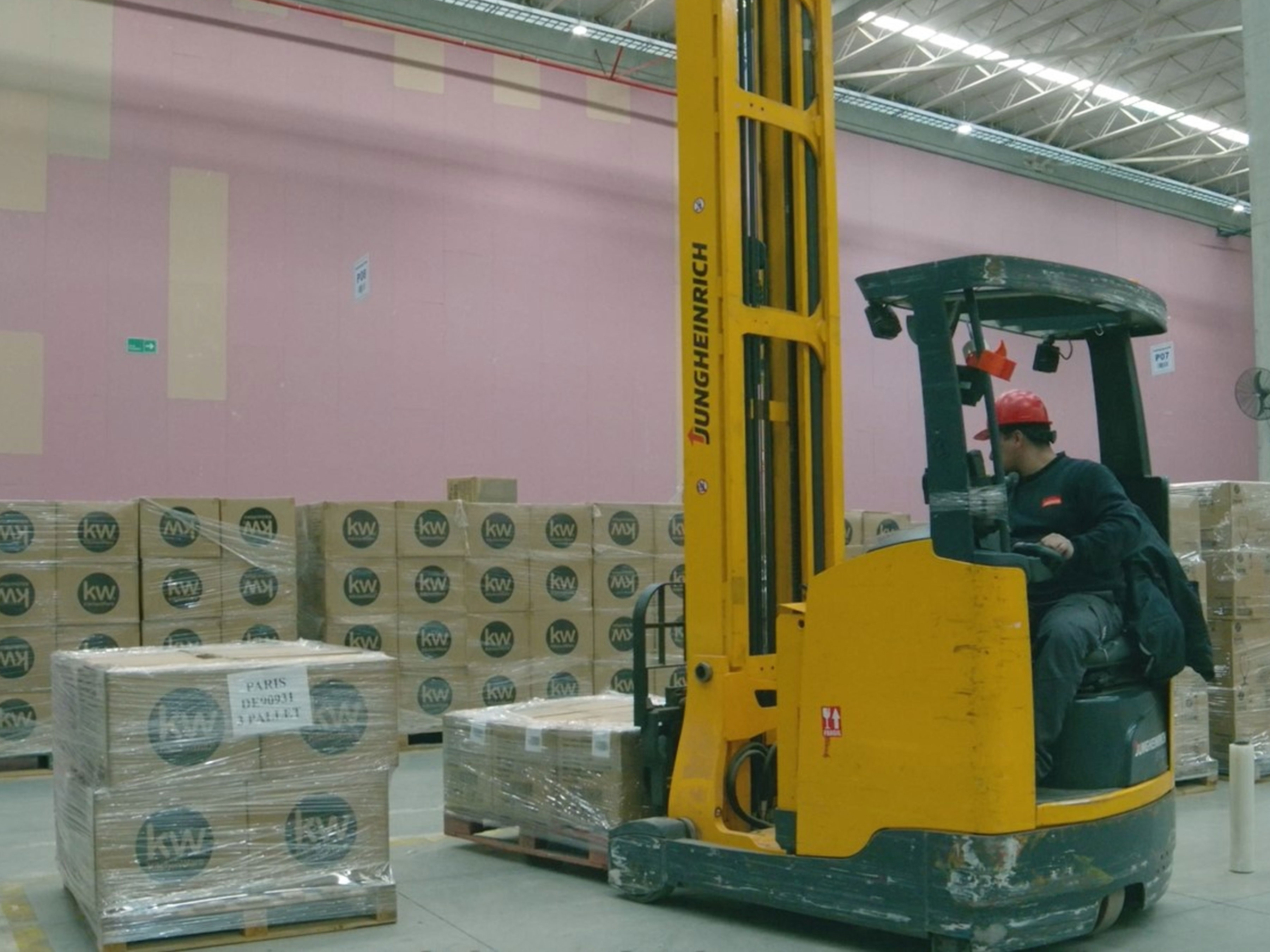 Worker in a warehouse moving pallets