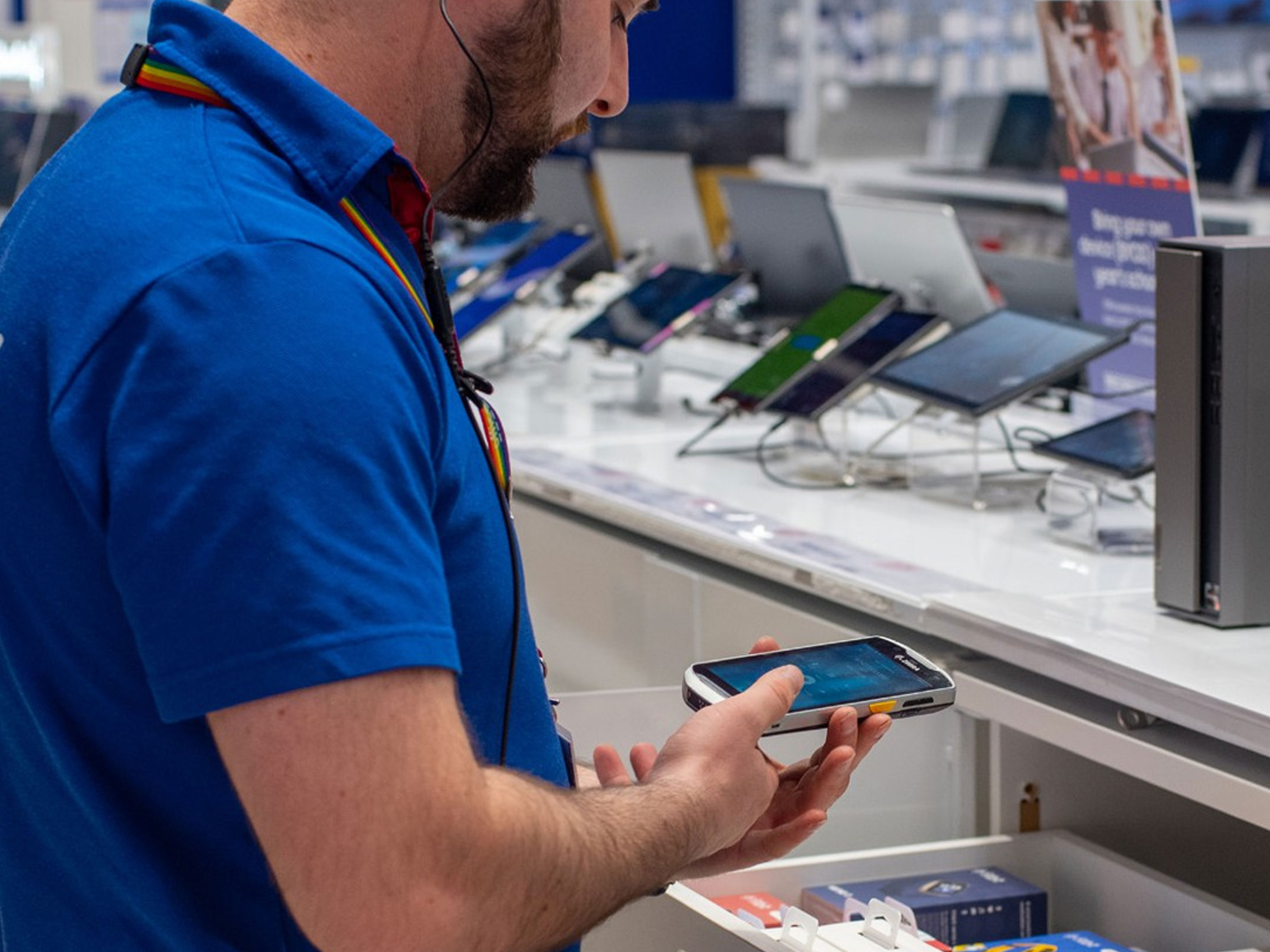 Officeworks employee using a Zebra mobile computer