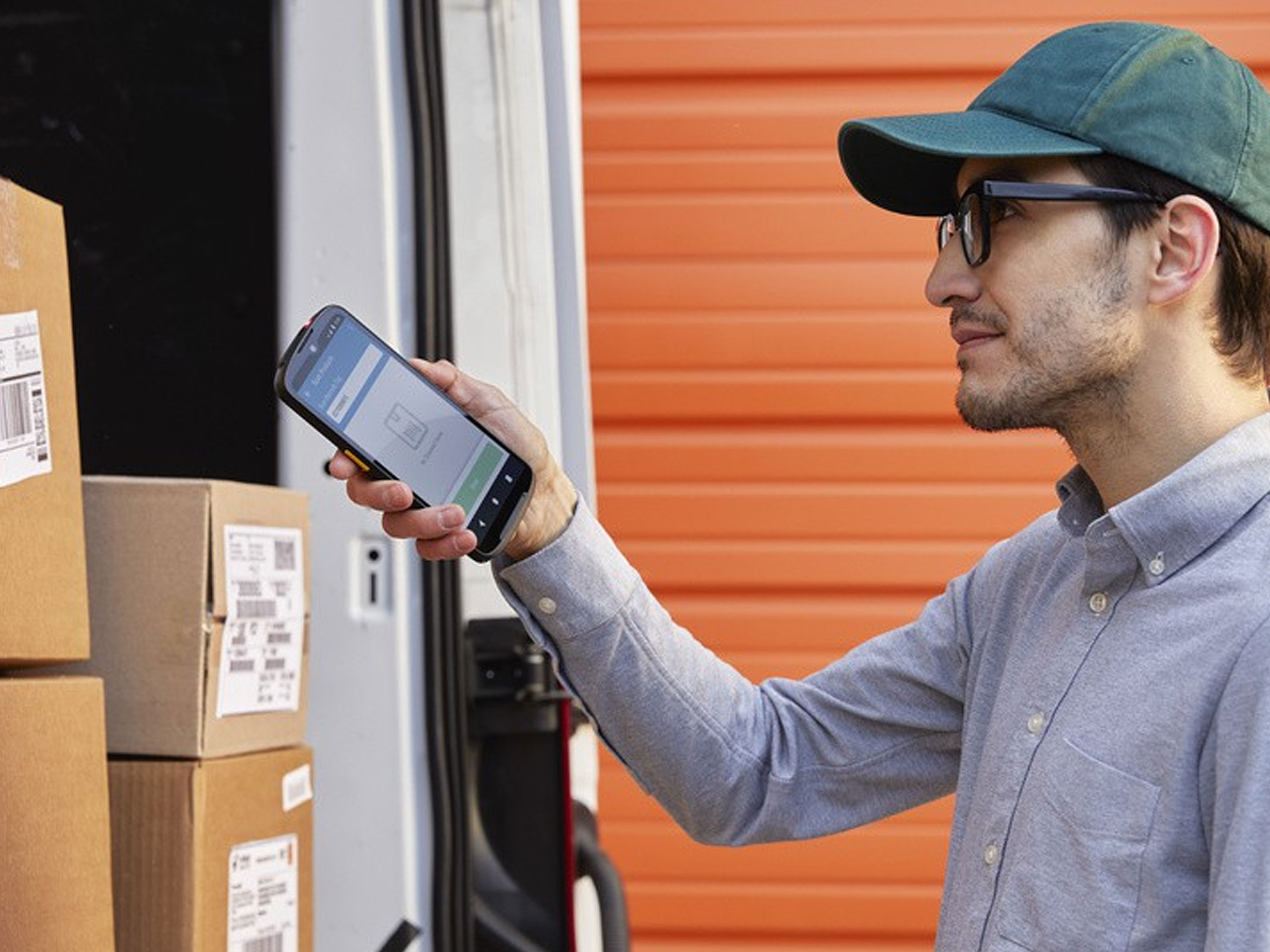 Worker scanning boxes in delivery van