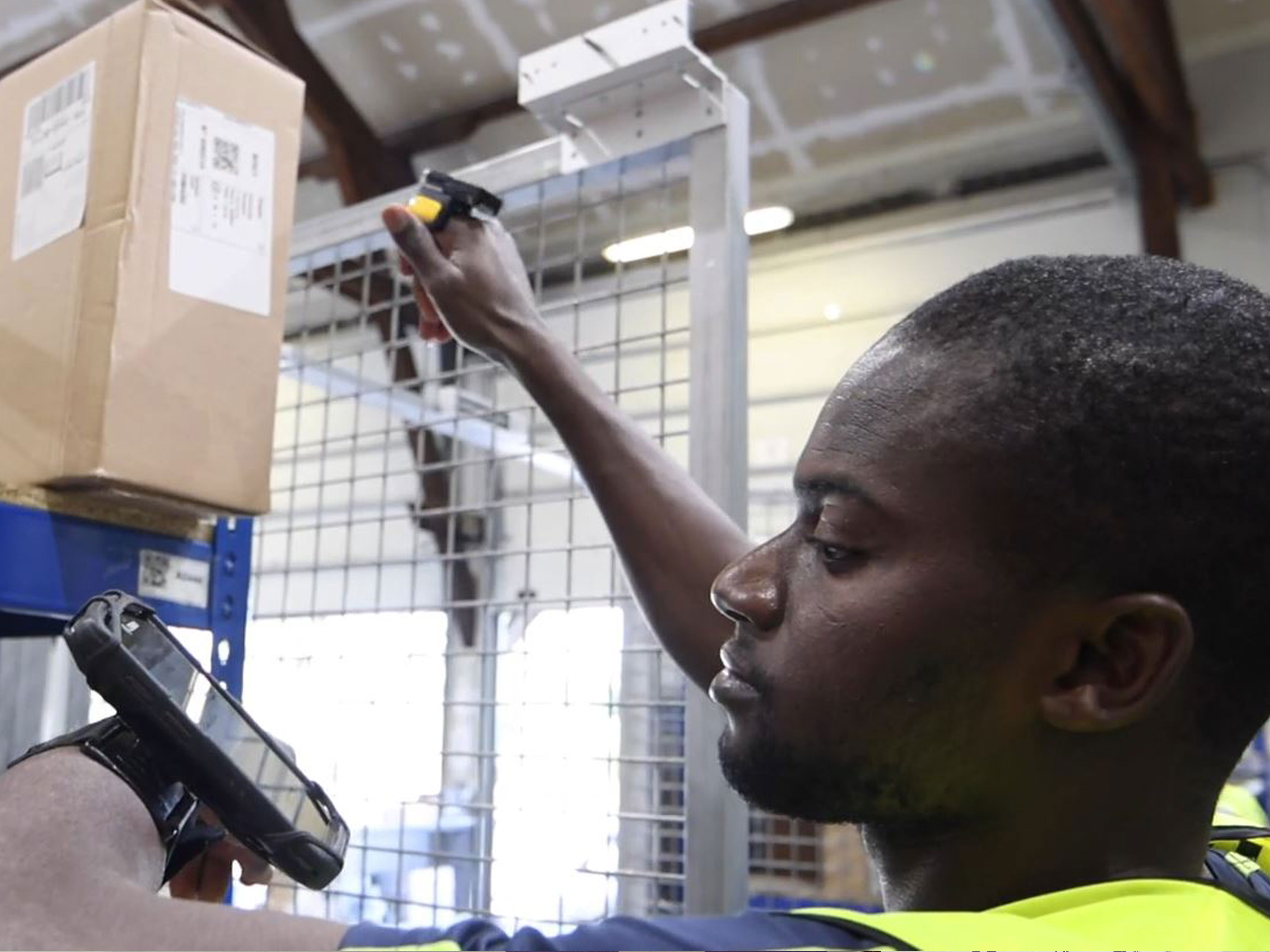 Worker scanning boxes in a warehouse