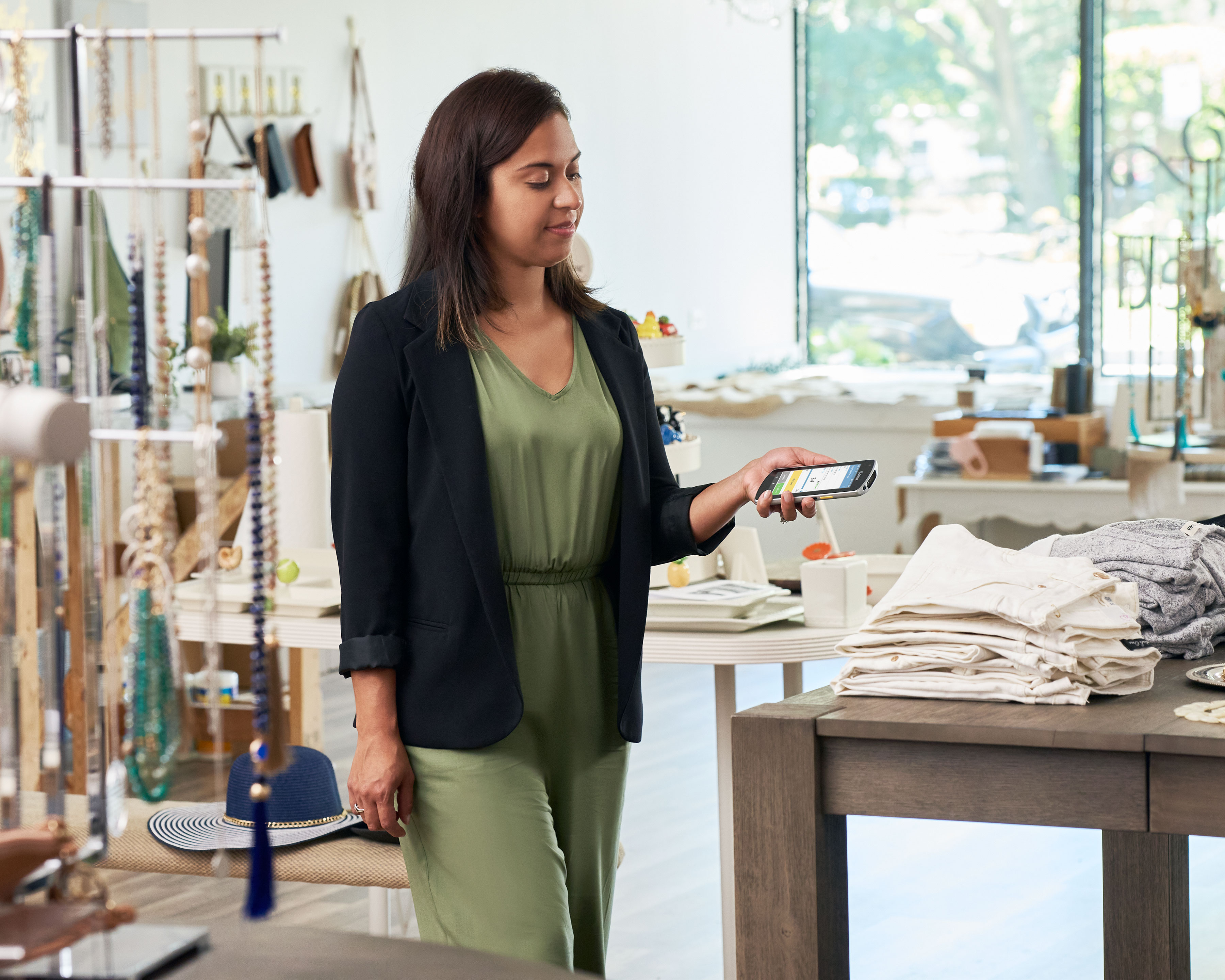 Person using a Zebra EC50 EC55 handheld computer in a clothing store