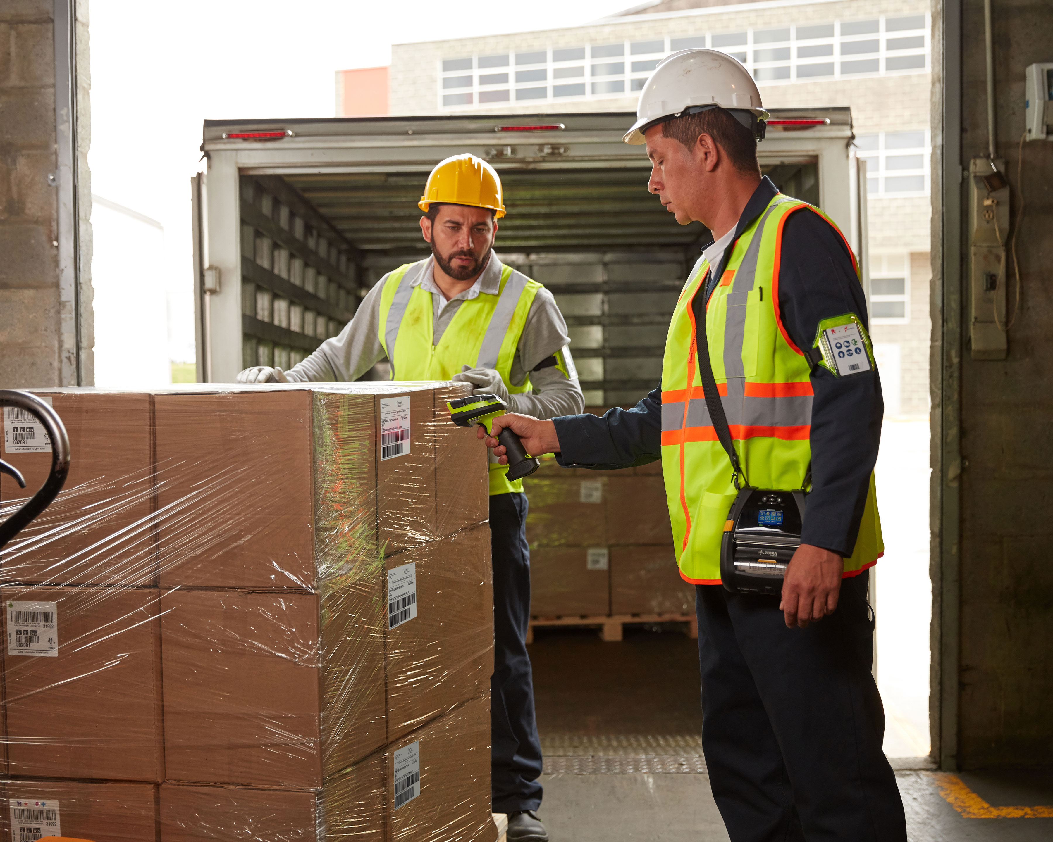 Warehouse worker uses Zebra LI3600 barcode scanner with label parse software to scan shipment boxes