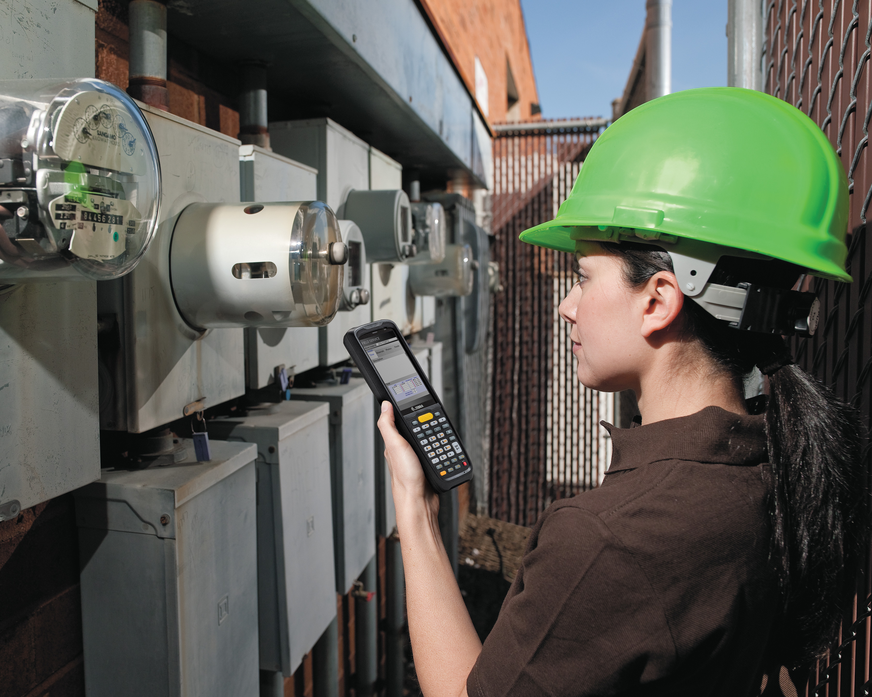 A female worker using a Zebra MC9300 handheld computer