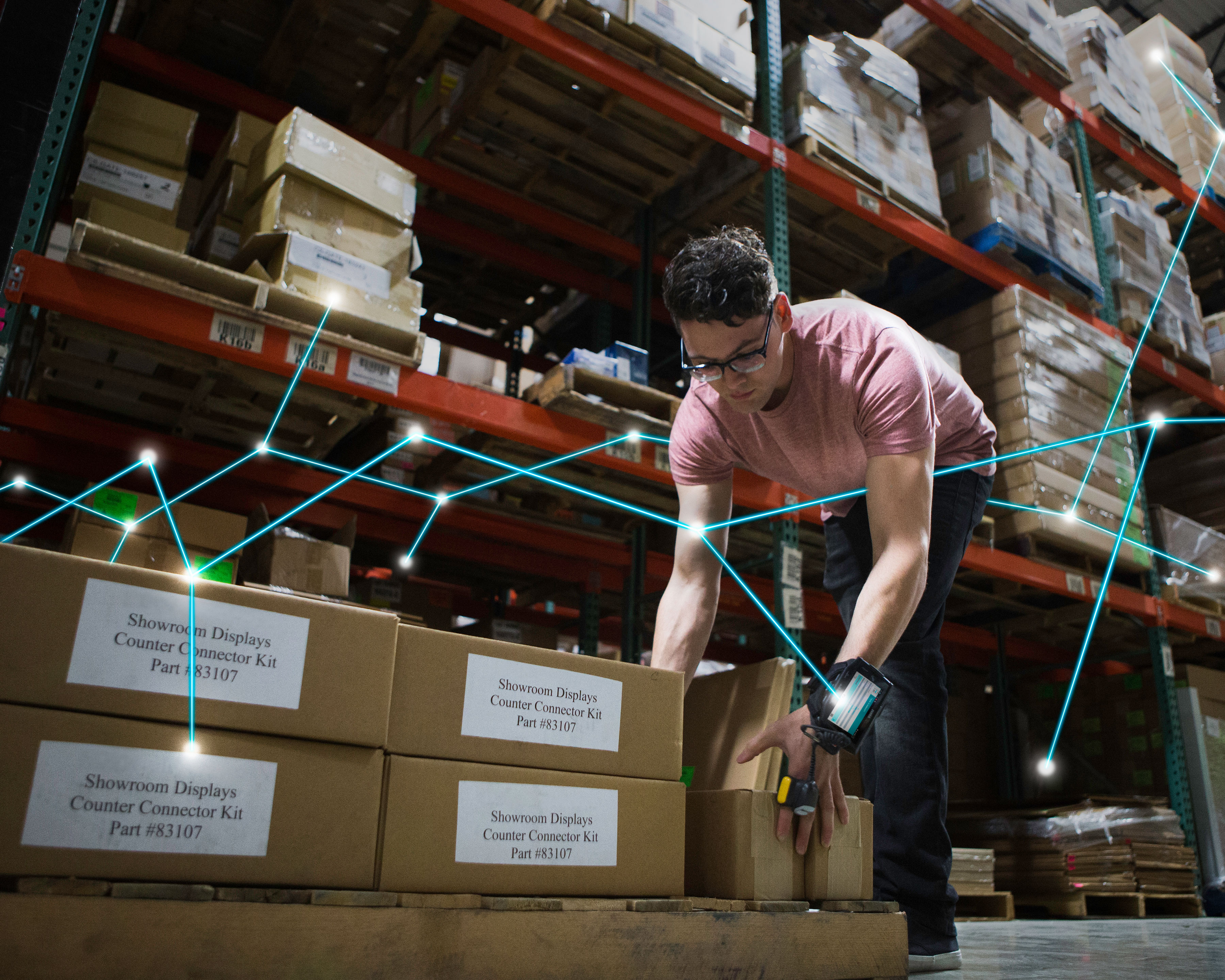 Warehouse worker wears Zebra RS4000 ring scanner for easy mobility while picking warehouse boxes