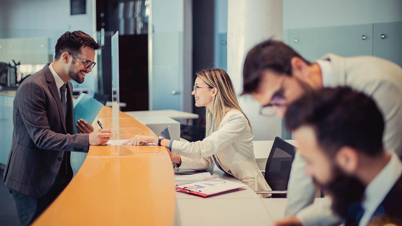 A bank branch associate helps a customer