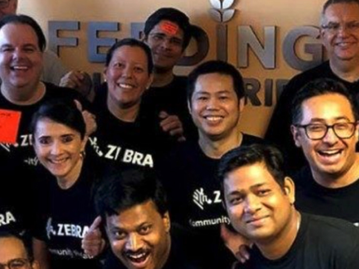 Group of zebra employees wearing zebra t shirts