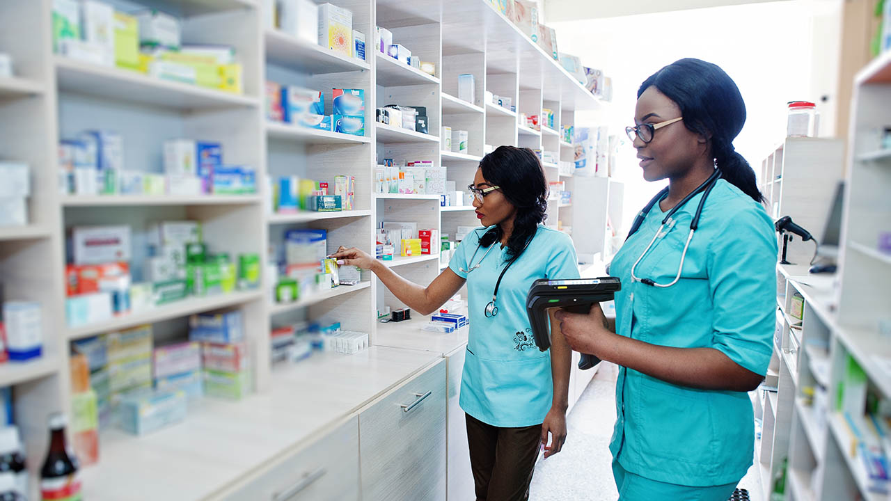 Two african american pharmacist working in drugstore at hospital pharmacy. African healthcare.