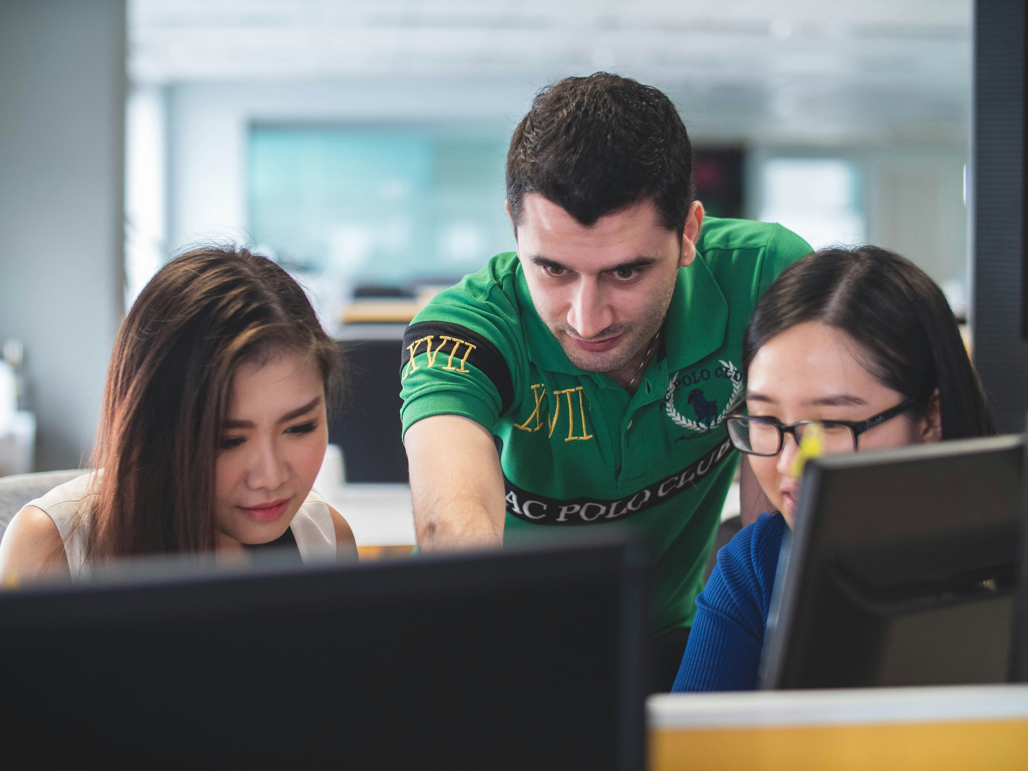 Partner Blog - Man Pointing at Screen Over Women's Shoulders